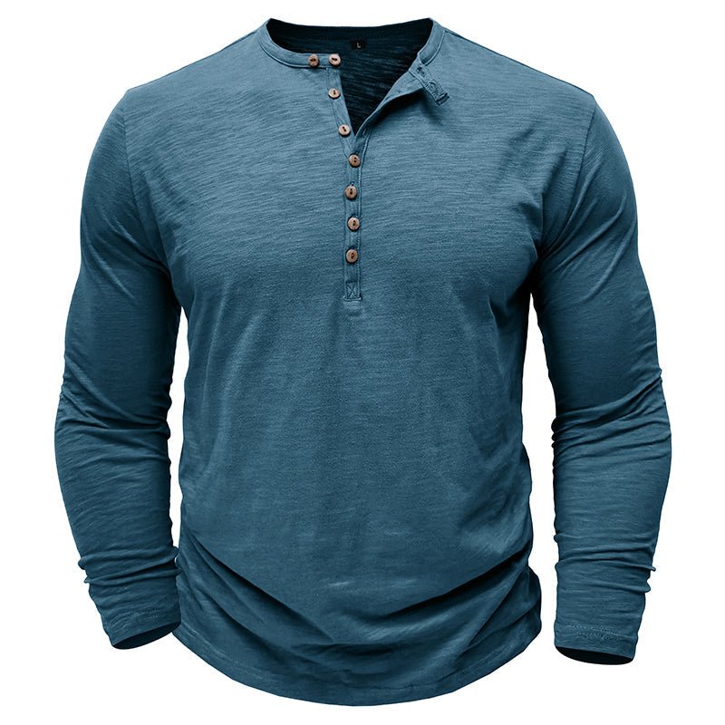 Man walking outdoors in a comfortable long-sleeve henley shirt, showcasing casual fashion & movement