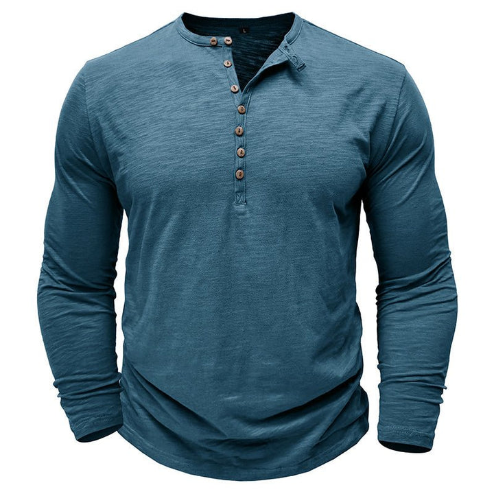 Man wearing a classic black long-sleeve henley shirt, showcasing casual and comfortable men's fashion