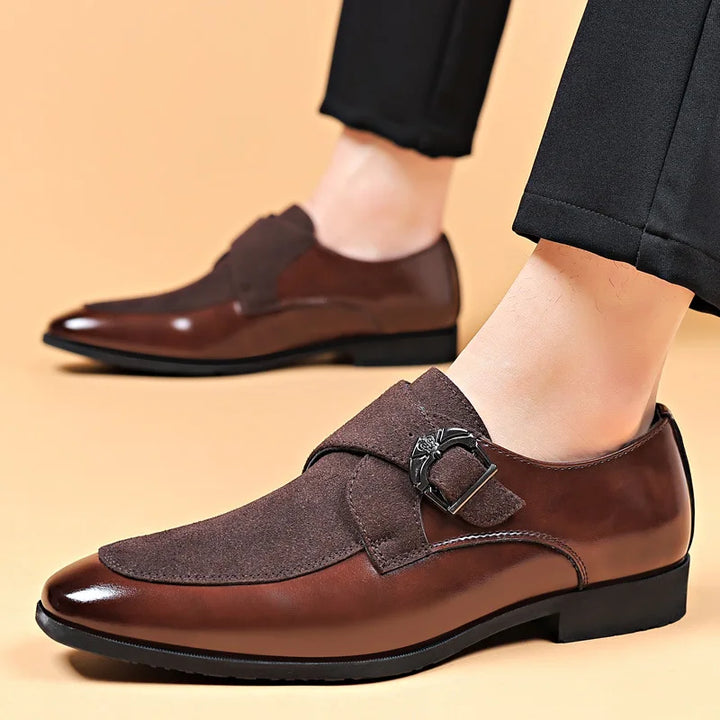 Close-up of a men's double monk strap dress shoe showing the detailed buckle closure and rich leather texture.