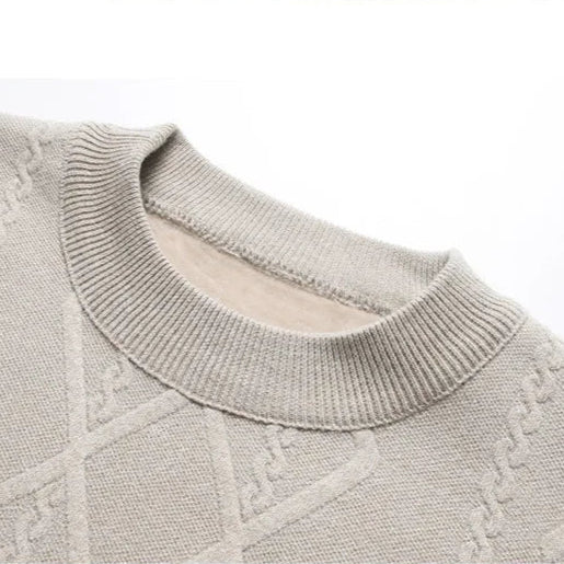 Folded men's burgundy cable knit crewneck sweater, showcasing its soft, warm material.