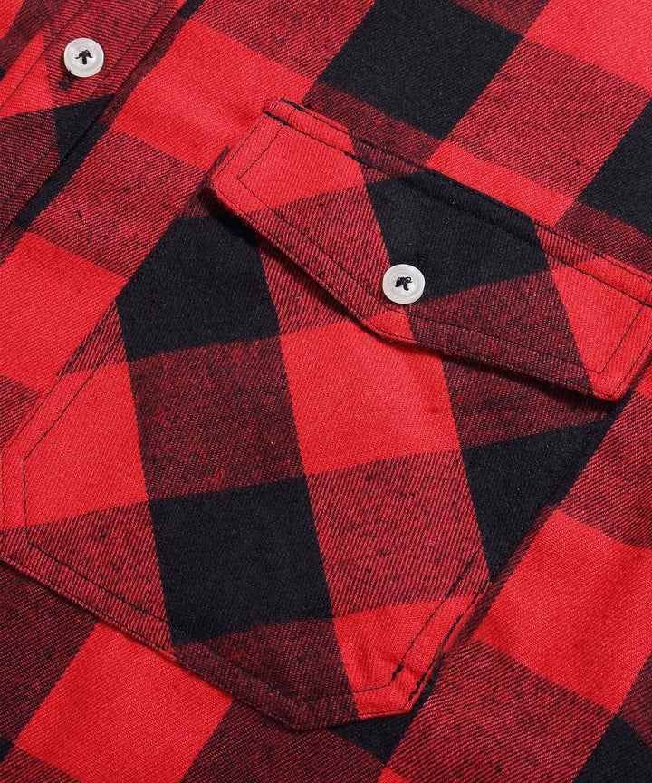 Detail of the sleeve and cuff of a men's plaid flannel shirt, long sleeve apparel