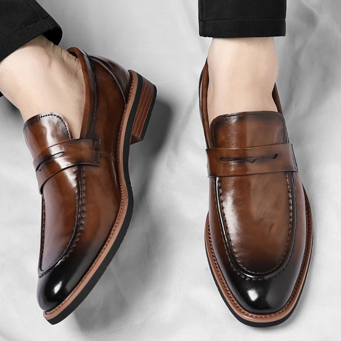 Pair of black polished leather penny loafers for men, ready for comfortable all-day wear