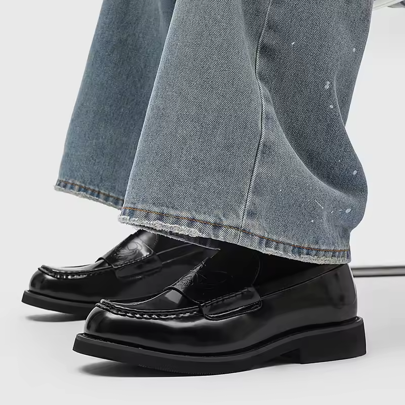 Comfortable men's loafers featuring a polished black leather finish. Versatile classic shoes for everyday wear & formal.