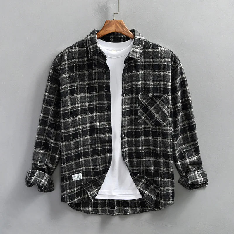 Close-up of men's casual plaid flannel shirt fabric, showcasing the detailed checked pattern and brushed cotton texture