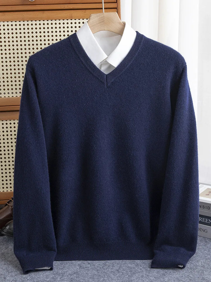 Detail of the V-neckline on a men's merino wool sweater, emphasizing classic knitwear design