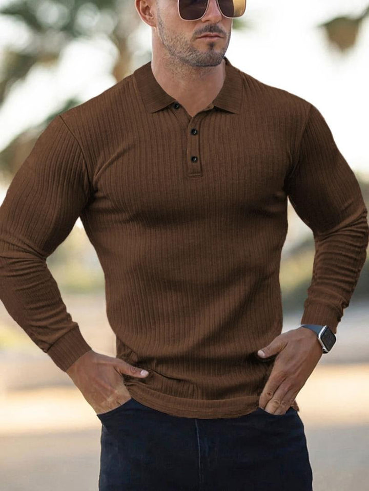 Man modeling a charcoal grey ribbed long-sleeve polo shirt, suitable for everyday men's fashion.