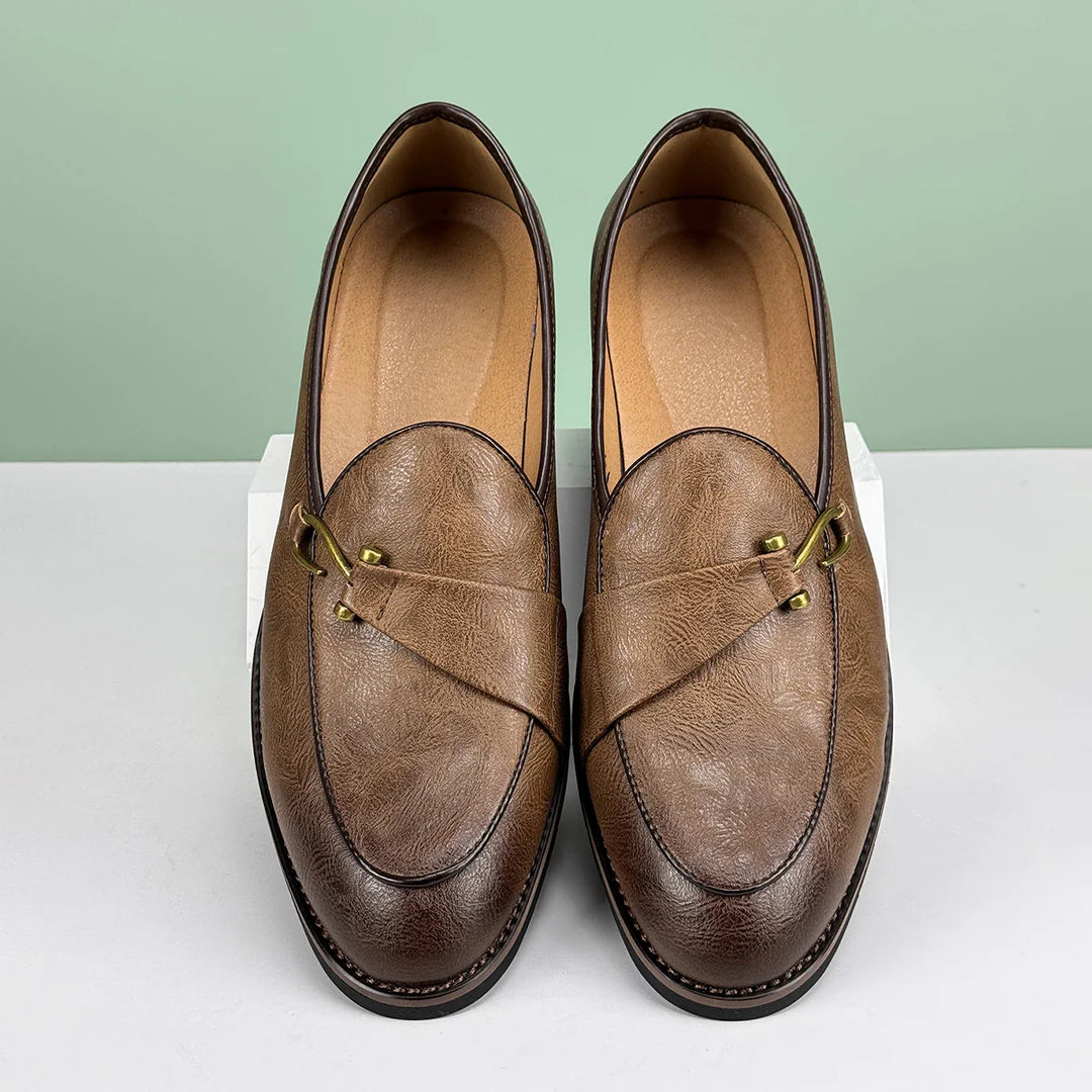Men's slip-on brown leather loafers with a shiny metal bit, comfortable footwear.