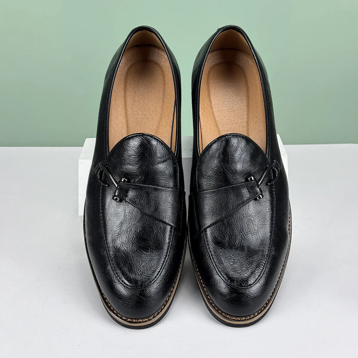 Close-up of a men's classic bit loafer, showing the metal bit detail and rich leather.