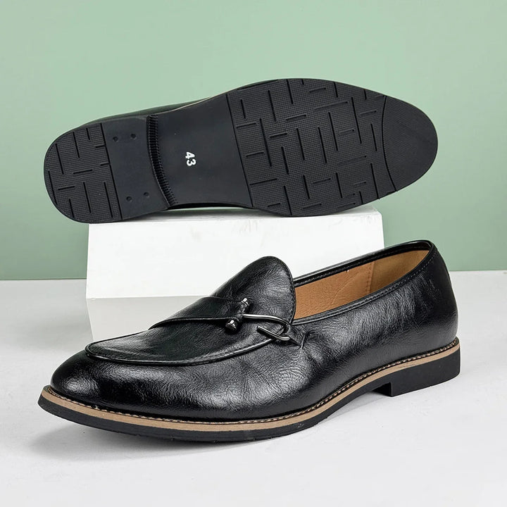 Front view of men's elegant slip-on bit loafers in smooth brown leather.