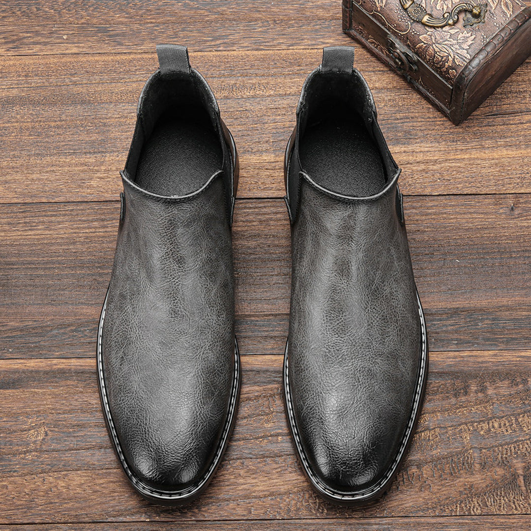 Full shot of Men's Classic Chelsea Boots worn with dark trousers, showcasing their sleek design