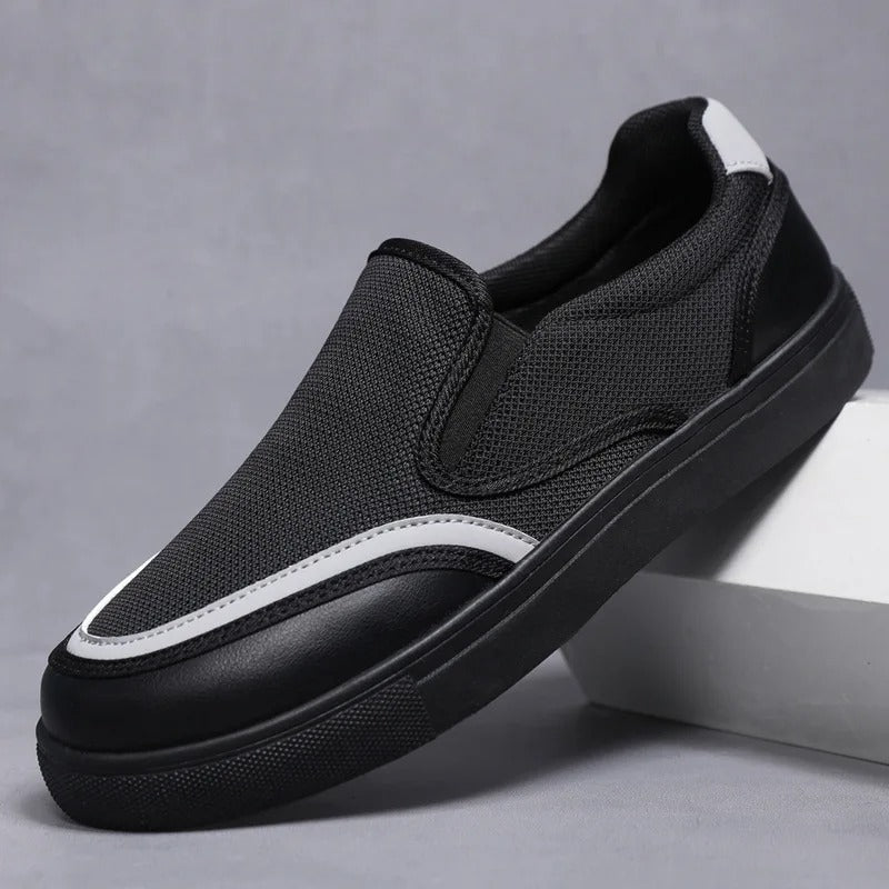 Stylish black men's slip-on loafers, versatile for casual or dress occasions.