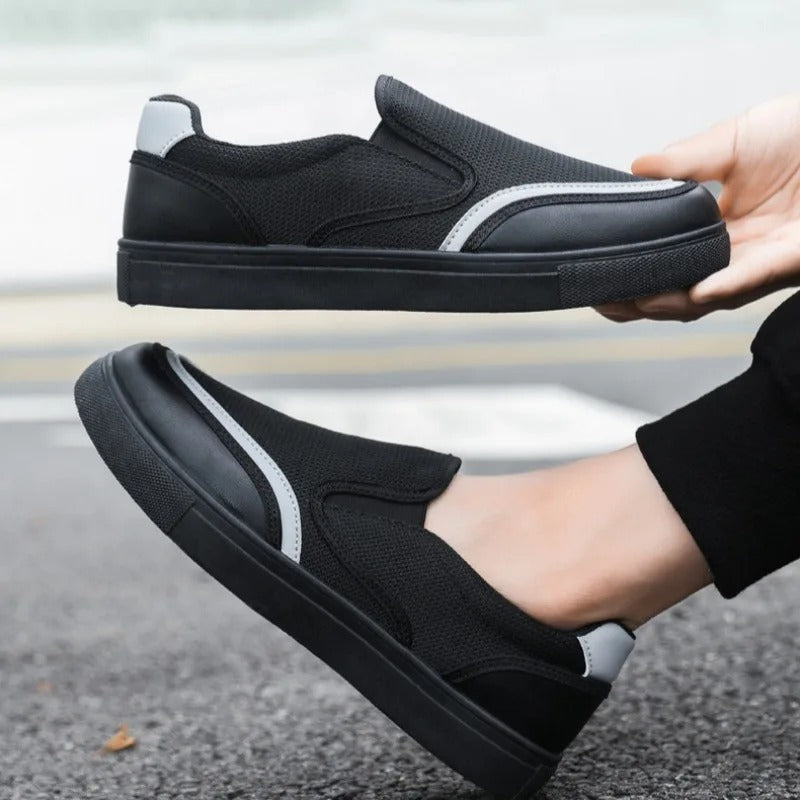 Side profile of men's black deck loafers, highlighting the comfortable, casual footwear.