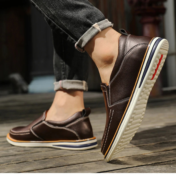 A man wearing the comfortable classic slip-on leather loafers, demonstrating the fit.