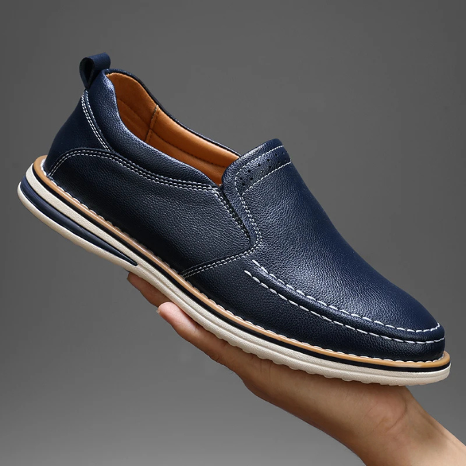 Close-up of the slip-on leather loafers, showing the classic brown leather and moc-toe stitching.