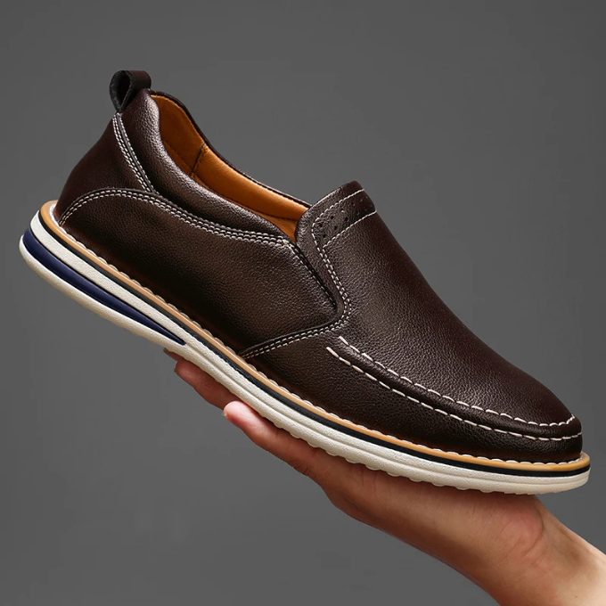 Back view of classic men's leather footwear, detailing the heel construction of the loafers.