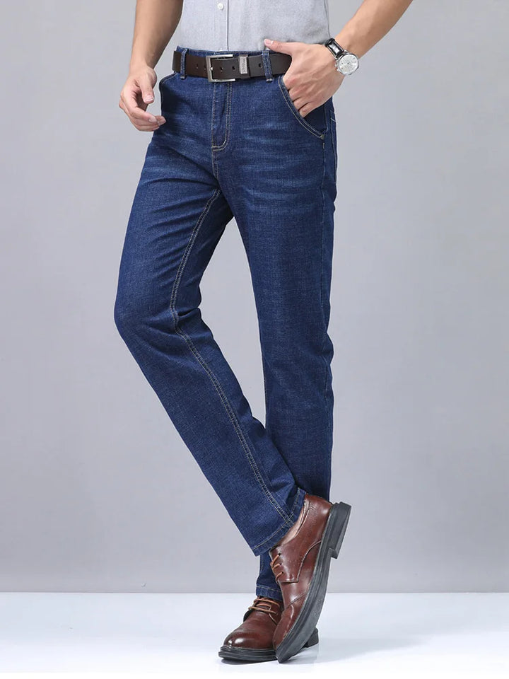 Close-up of the textured premium cotton fabric on men's straight fit blue denim jeans.