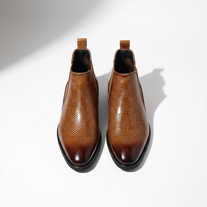 Footwear shot of men's sturdy leather Chelsea boots, built for longevity and classic style.