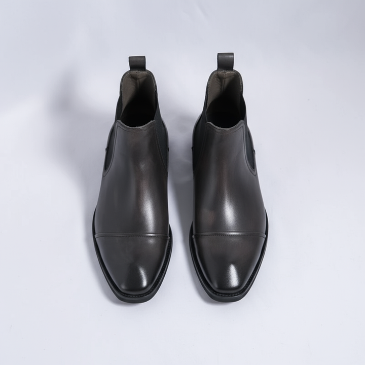 Collection of men's classic leather Chelsea boots in various colors: black, brown, tan, and oxblood.