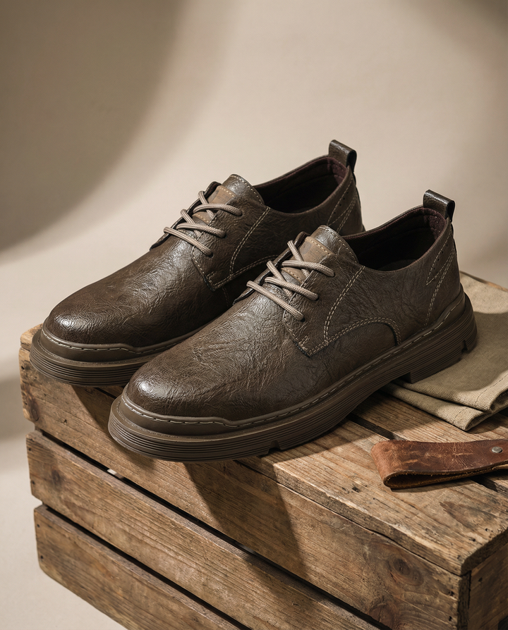 Close-up of men's black leather derby shoes with detailed stitching, ideal for work
