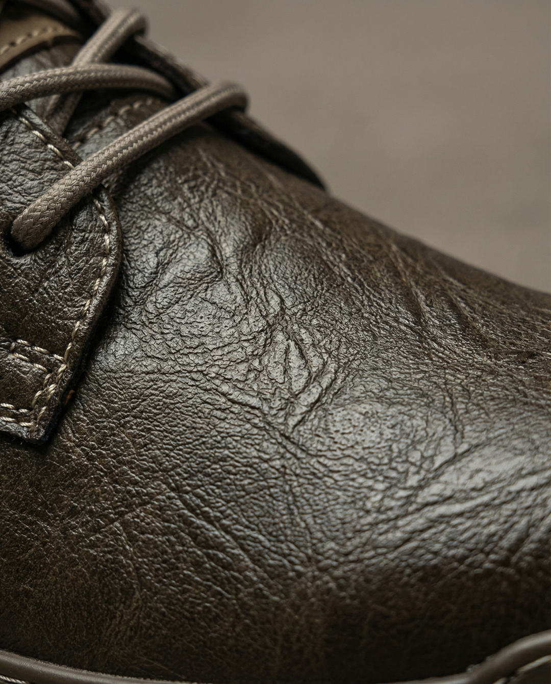 Detailed shot of men's vintage-style brown leather derby shoes, with fine lacing