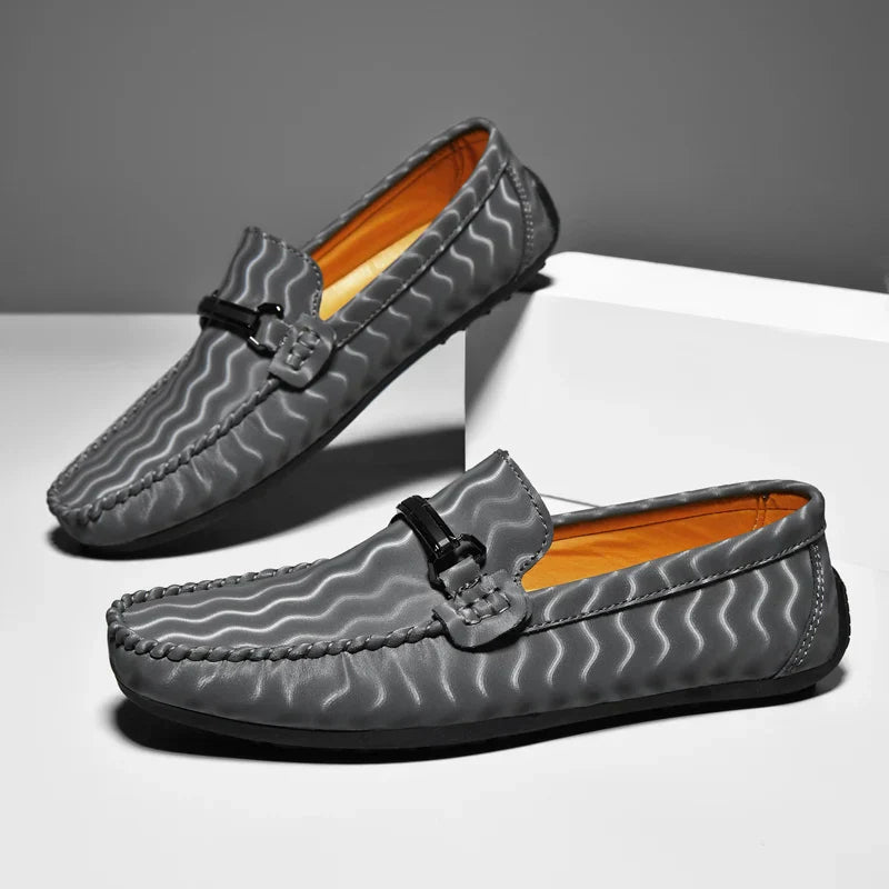 Pair of classic men's leather slip-on loafers in a rich burgundy, ideal formal dress shoes.