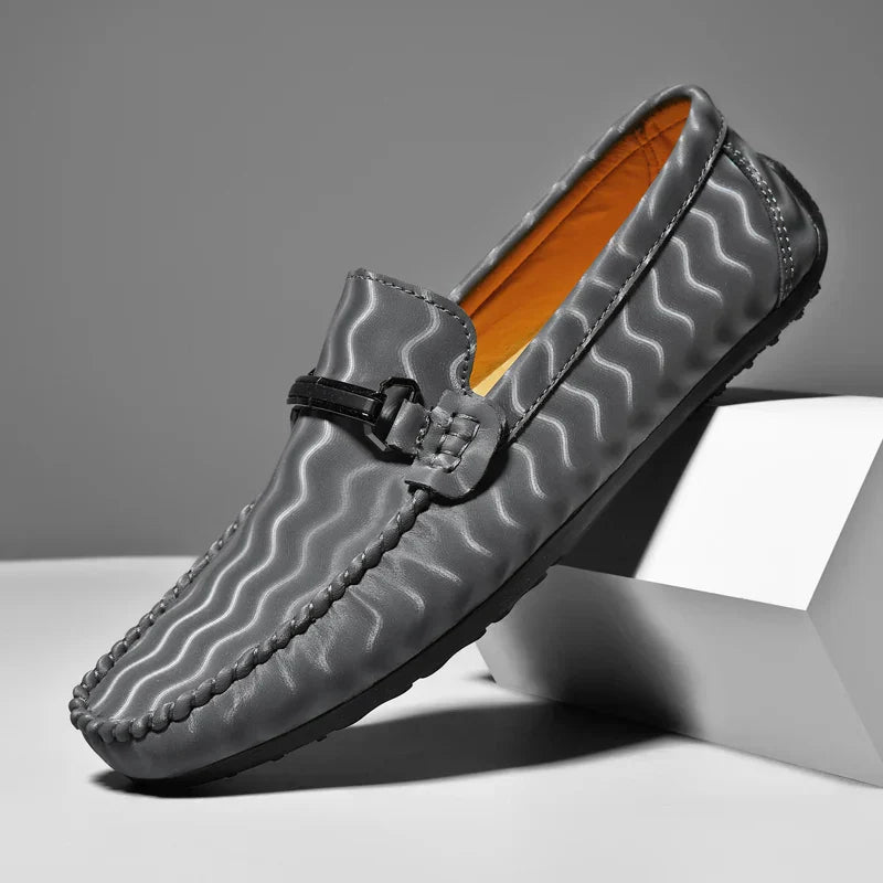 Men's classic leather loafers in navy blue, offering a smart and comfortable footwear option for any event.