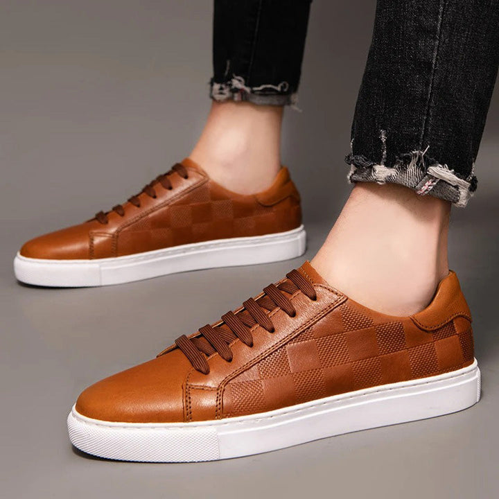 Pair of men's white leather low-top sneakers, offering clean and elegant everyday casual footwear style