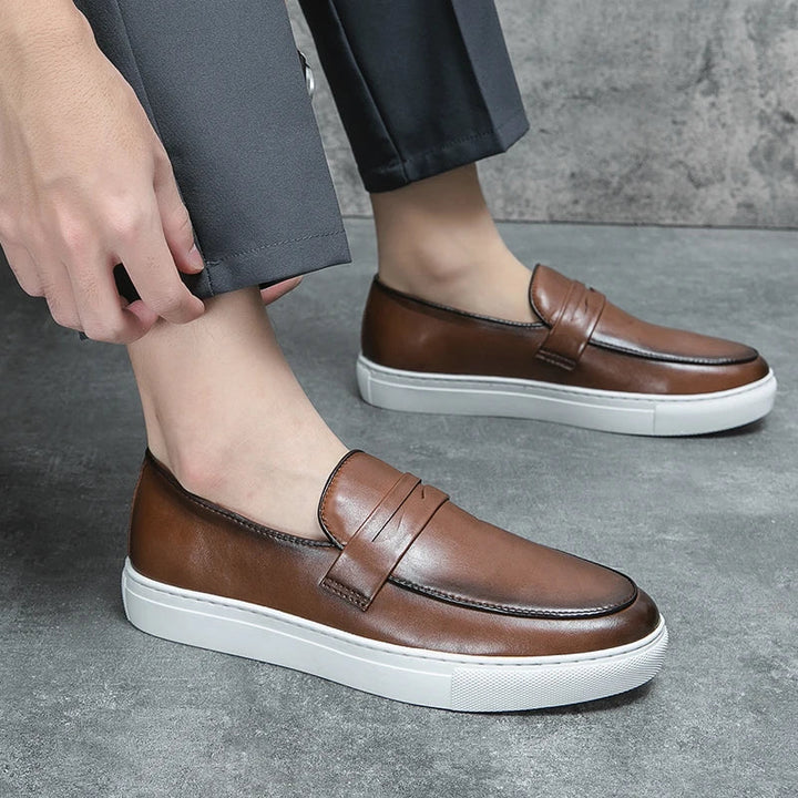 Group of men's leather loafers in various colors: black, tan, and brown, for versatile styling.