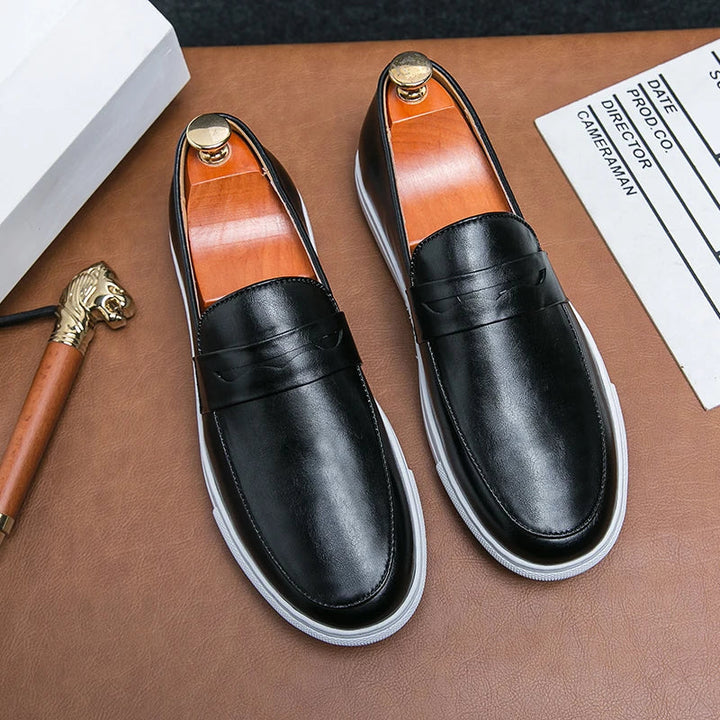 Pair of men's black leather loafers, ideal dress shoes for formal and casual occasions.