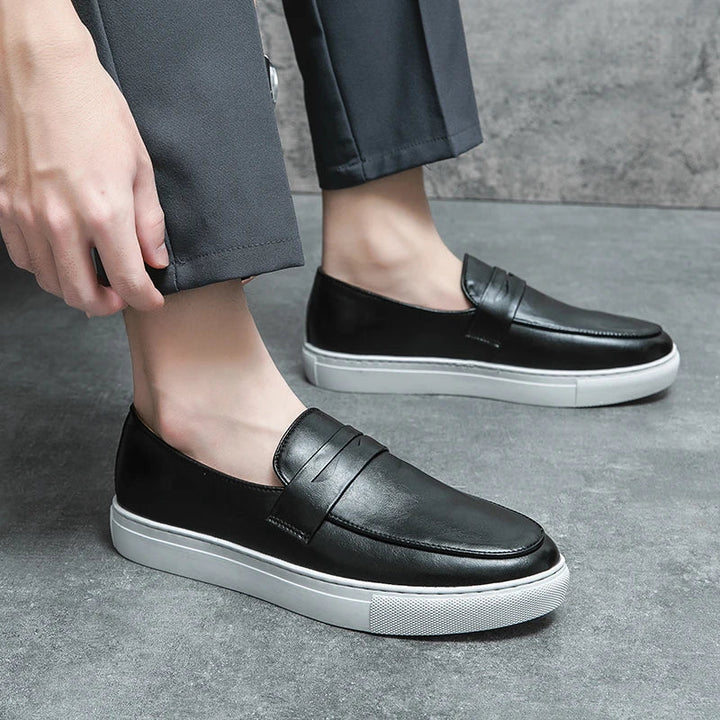 Side profile of men's brown leather loafers, showcasing the sleek design and comfortable fit.
