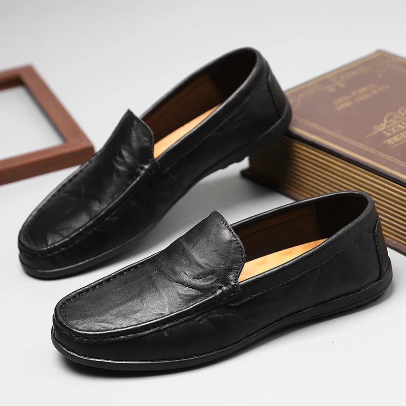 Comfortable men's black leather slip-on loafers, perfect for a refined casual look.
