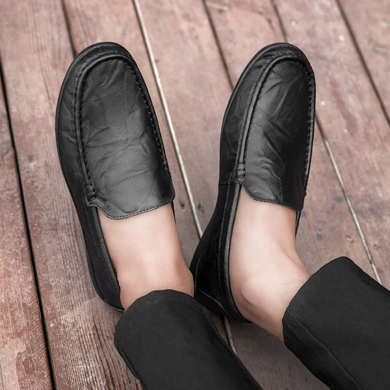 Stylish men's brown leather slip-on loafers with classic stitching, versatile for any outfit.