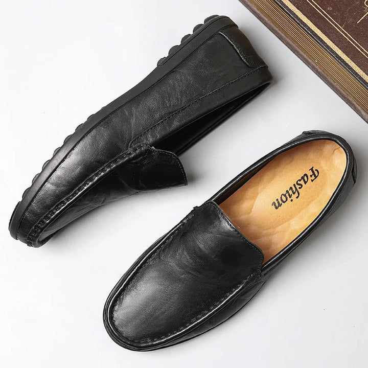 Close-up of men's sleek leather slip-on loafers, highlighting premium material and comfort.