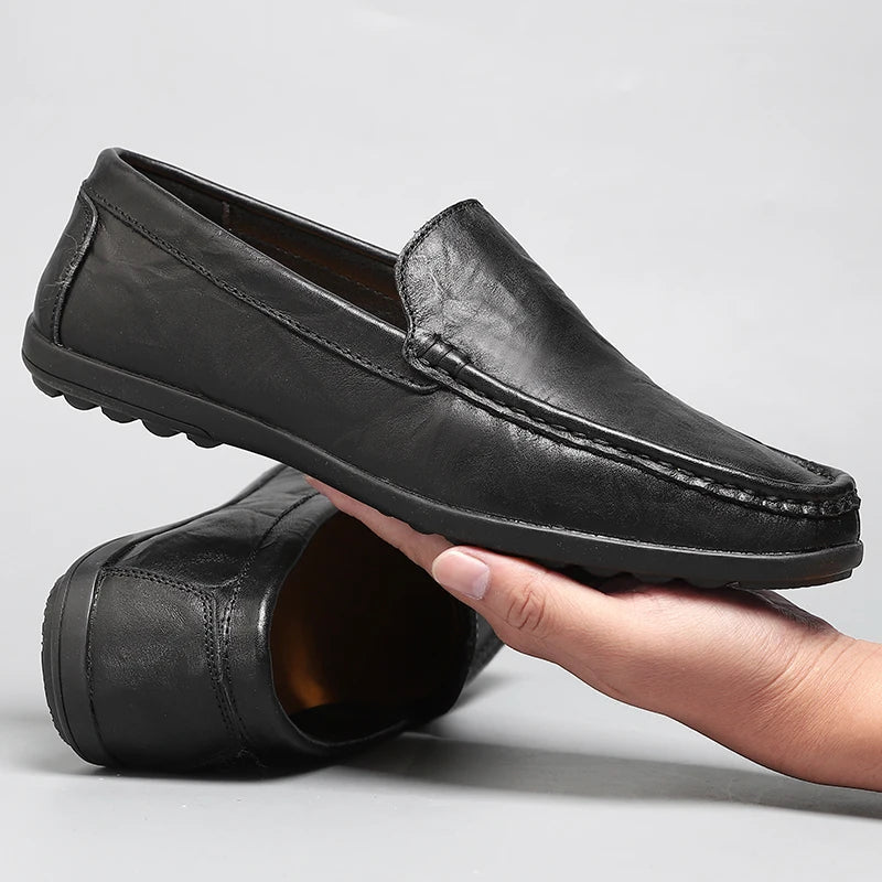 Pair of men's classic dark brown leather slip-on loafers, a timeless addition to men's footwear.