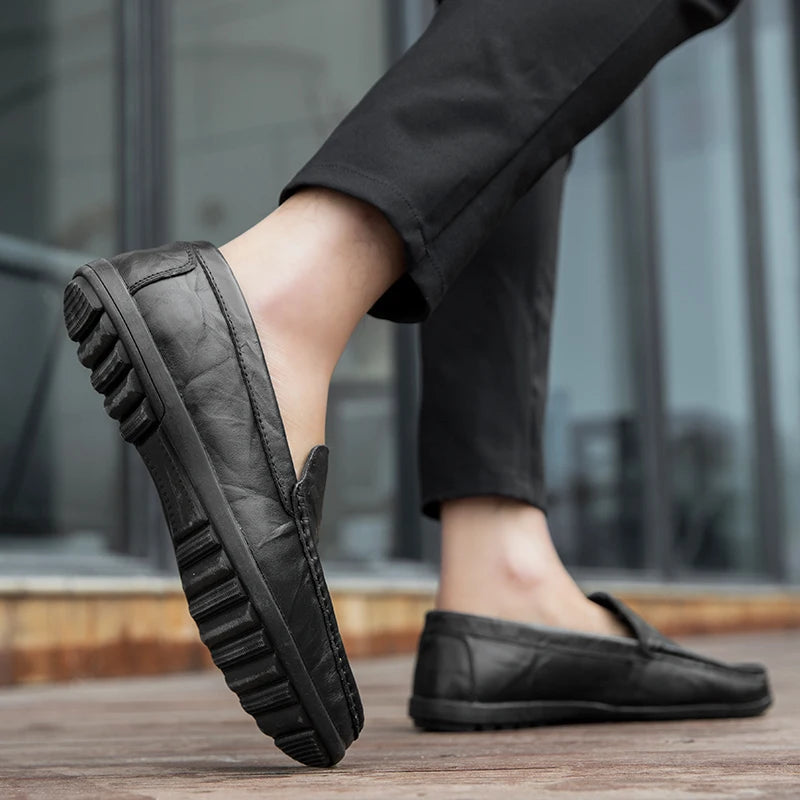 Elegant men's navy blue leather slip-on loafers, suitable for both casual and dress occasions.