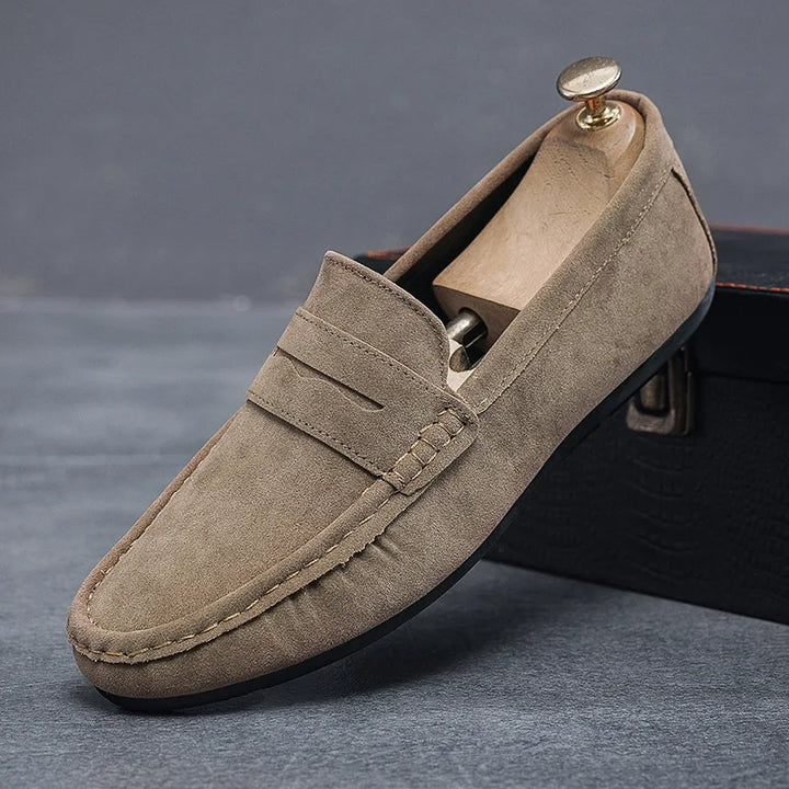 Close-up of men's classic black slip-on loafers, showcasing timeless casual shoes.