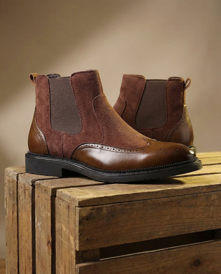Pair of men's dark brown suede Chelsea boots, side view, showing durable sole. Versatile footwear.