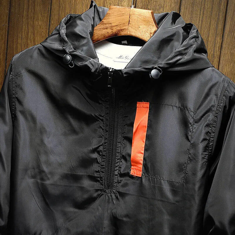 Lightweight men's windbreaker jacket with a hooded, half-zip design. Comfortable color block outerwear for men.
