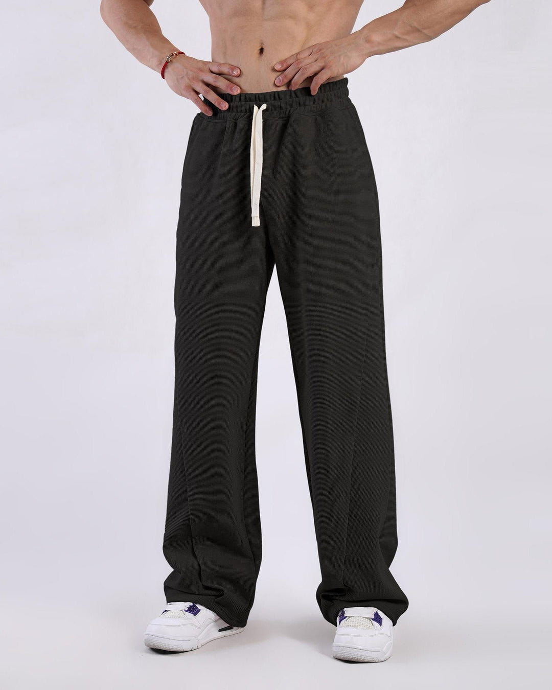 Detail of waistband and drawstring on men's waffle knit comfort pants