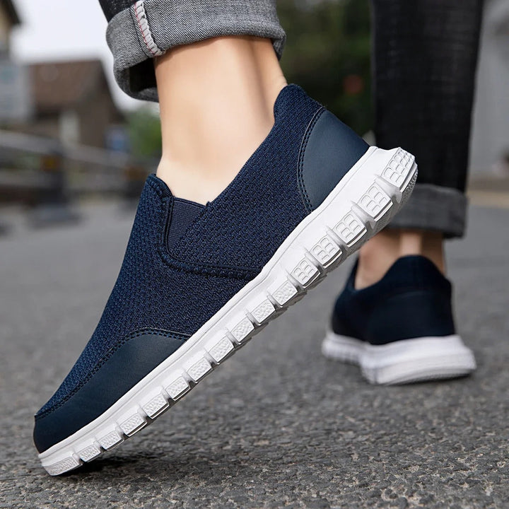 Men's slip-on knit loafers, available in khaki and navy blue, offering lightweight comfort.