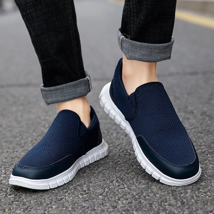 Top-down view of men's navy blue knit slip-on shoes, designed for ultimate comfort and casual style.