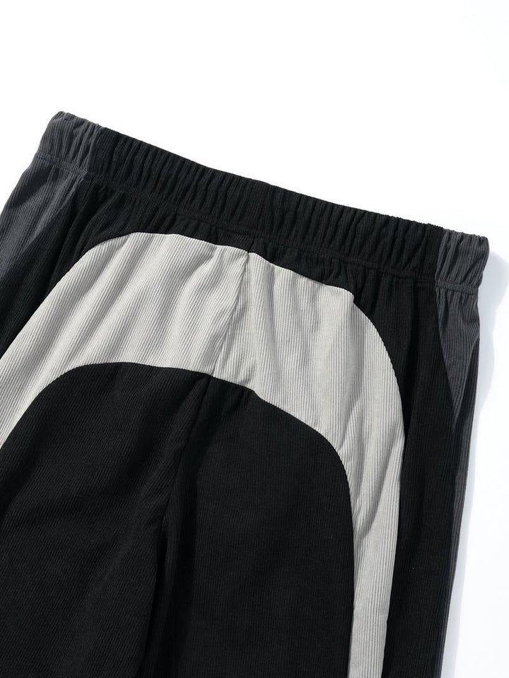 Stylish men's corduroy joggers in a vibrant color-block design, versatile for athletic or casual outfits.