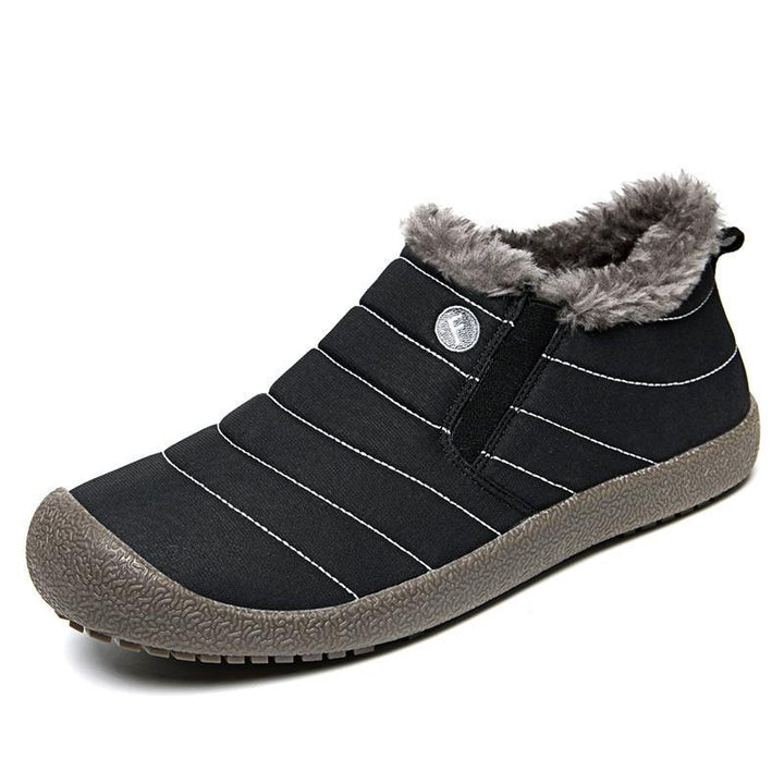 Pair of men's cotton snow boots displayed on a snowy surface, ready for winter