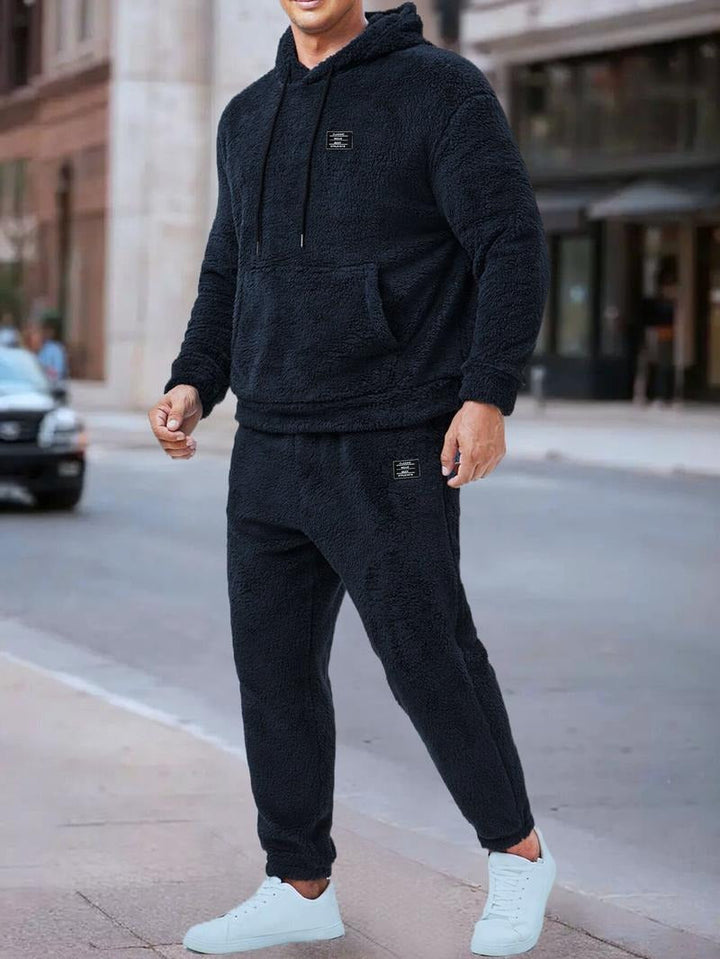 Comfortable men's fleece tracksuit for loungewear, featuring a stylish hoodie and pants.