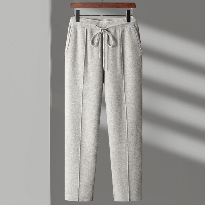 Man stretching in merino blend lounge pants, emphasizing freedom of movement and softness.