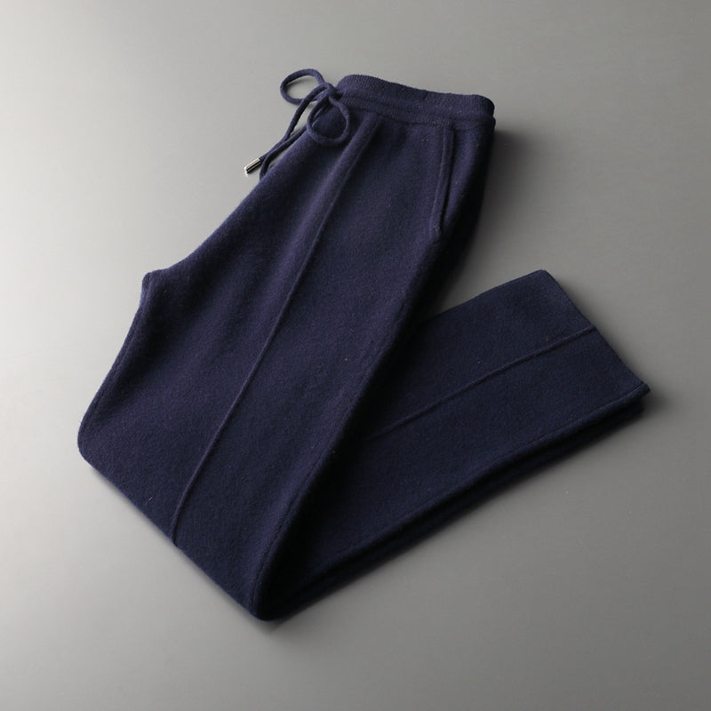 Stack of two men's cozy merino blend lounge pants in different shades, soft casual wear.