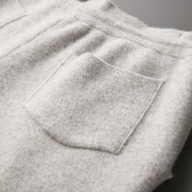 Man relaxing in mens merino blend lounge pants, showcasing comfort & casual style, full length.