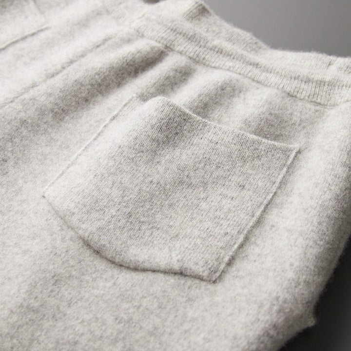 Man relaxing in mens merino blend lounge pants, showcasing comfort & casual style, full length.
