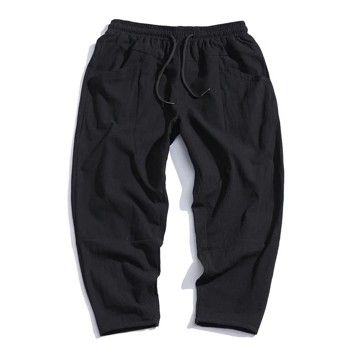 Black men's cropped drawstring chino pants, stylish, comfy, and versatile.
