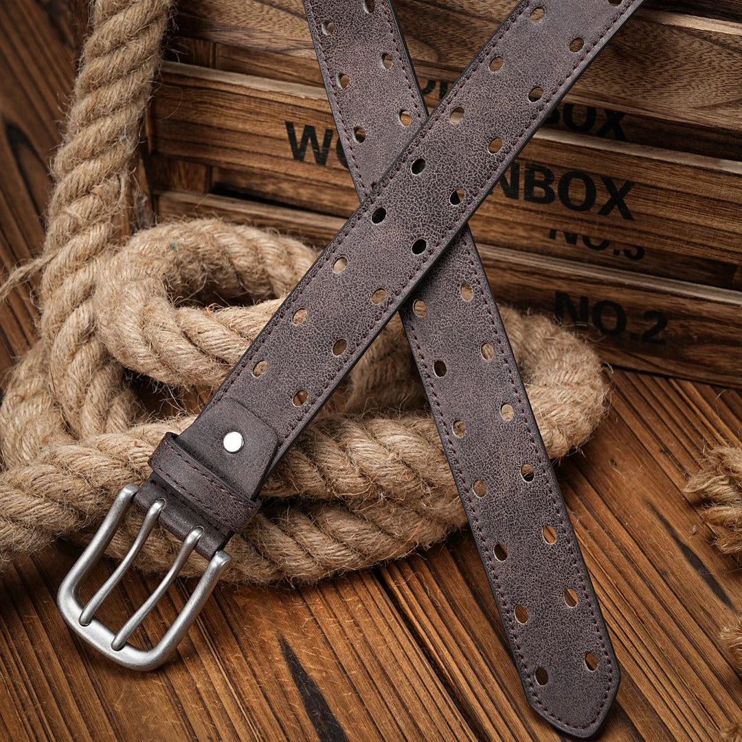 Texture shot of men's distressed leather belt, showcasing the rich brown color and detailed perforated pattern.